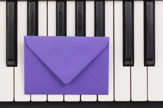 Funny arrangement envelope on the piano keybords - Flat lay image