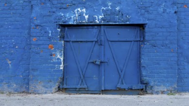 Old blue door closed in a wall