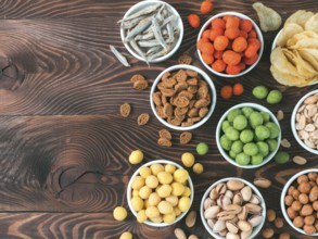 Assortment of different snack for beer, wine, party. Peanuts in coconut glaze, green vasabi, red