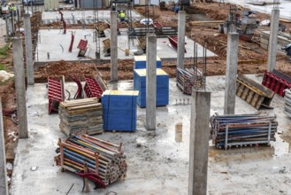 Construction site with reinforced concrete columns and galvanized steel struts and wooden