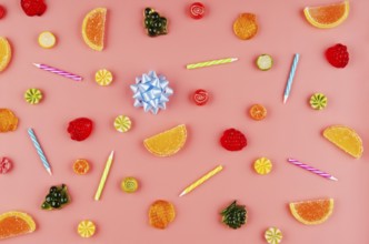 Flat lay view at sweet background of different type candies on pink