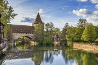 Pedestrian chain bridge (Kettensteg) and the medieval city wall behind it, Nuremberg, Germany,