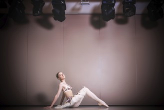 Young beautiful graceful caucasian ballerina practice ballet positions in tutu skirt. Classical