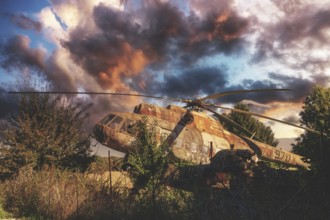 An abandoned, rusty helicopter stands overgrown in nature under a dramatic, cloudy sky at sunset,