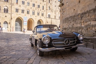 VOLTERRA, ITALY, OCTOBER 15, 2023, A Mercedes Benz 190SL vintage car in the town center of Volterra