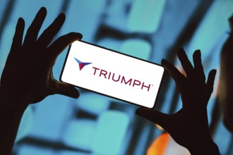 In this photo illustration, the Triumph Group logo is displayed on a smartphone screen
