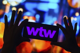 In this photo illustration, the Willis Towers Watson (WTW) logo is displayed on a smartphone mobile