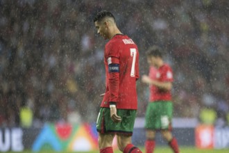 Football match, Cristiano RONALDO CR7 Portugal in the pouring rain, walking to the left and with