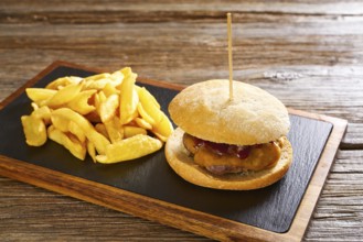 Burguer and french fries potato chips on wood table