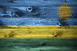 Rwanda flag on wooden planks background wood flag
