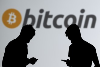 Business person using phone background Bitcoin logo