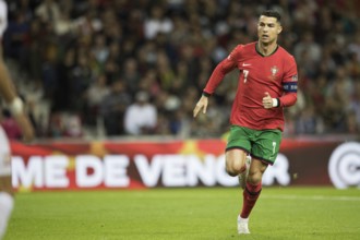 Football match, captain Cristiano RONALDO CR7 Portugal running slowly to the left with a