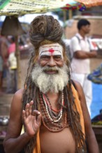 Portrait of a sadhu on ghat by Ganges river, Varanasi, India, Asia