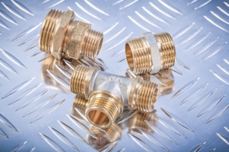 Brass hose nipples equal tee on fluted metal sheet plumbing concept