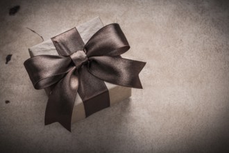 Present box with tied bow paper on vintage background