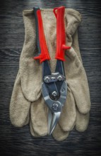 Protective gloves steel cutter on wooden board