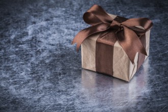 Giftbox on scratched metallic background holidays concept