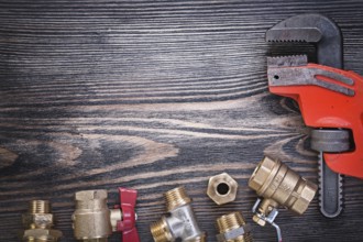 Composition of plumbers equipment on wooden board plumbing concept