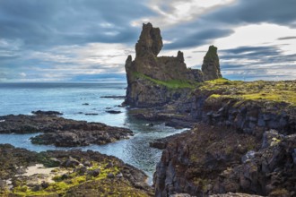 Magnificent Iceland. Northern sea coast. Picturesque ancient Skerries in summer cloudy day