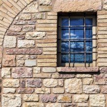 Assisi Italy : Window on medieval stone wall