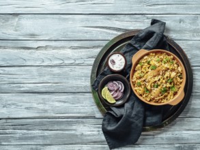Pakistani food - biryani rice with chicken and raita yoghurt dip. Delicious hyberabadi chicken