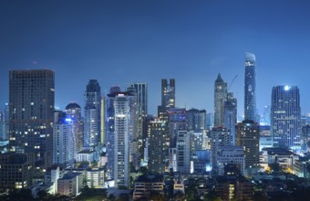 Cityscape night view of Bangkok modern office business building and high skyscraper in business