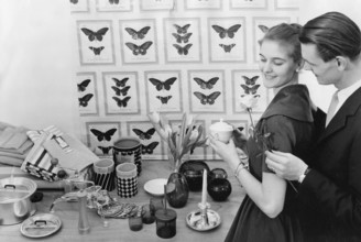 In the 1950s. A young with the typical 1950s designed objects, household appliencies and details on