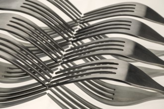 Abstract artistic picture of wavy forks, which form a wave pattern by means of mirroring