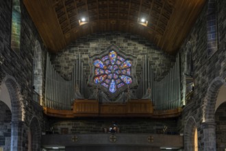 Galway, Ireland, 28 July, 2022: close-up view of the organ and stained glass window in the nave of
