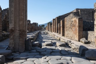 POMPEII, ITALY, MAY 04, 2022, A crosswalk of a typical Roman road in the ancient city of Pompeii,