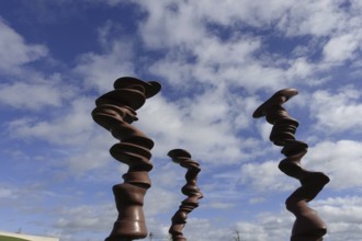 Würth Museum 2, Abstract wooden sculptures tower up into the partly cloudy sky, Carmen Würth Forum,