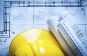 Hard hat construction drawings on blueprint