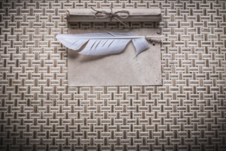 Vintage clean sheet paper roll plume on woven wooden matting