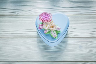 Heart-shaped present box on wooden board holidays concept