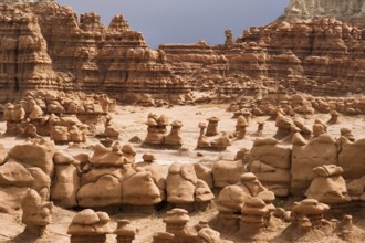 Stone figures in Goblins valley with parting storm on a background