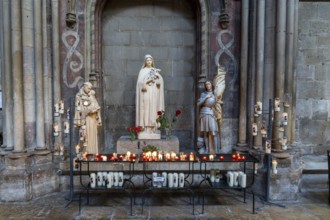 Dijon, France, 14 September, 2022: votive candles and altar in a side chapel of the Notre Dame of