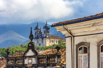 Facades of historic houses and churches with the mountains of the city of Ouro Preto in Minas