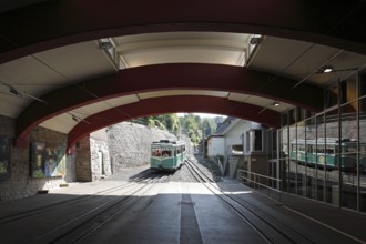 Valley station with arriving railcar
