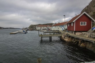 Beautiful village landscape in a fjord. Fishermen and restaurants in the evening at sunset. Boats