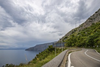 Coastal landscape shot. View from a road leading along the sea and through a breathtaking green