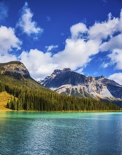 Magic mountain lake Emerald in Canada. The emerald-green lake surrounded by a pine forest