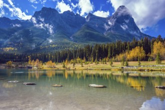 Shining day in Canmore. The famous Three Sisters mountains in the Canadian Rockies. Concept of