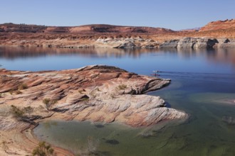 Antelope Canyon in the Navajo Reservation. Two boats with oars float near the water channel
