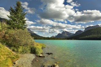 Northern lake surrounded by a wood and mountains in Canada