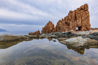 Rocce Rosse, the red rocks of Arbatax are reflected in a tidal pool, Arbatax, Tortoli, Ogliastra,