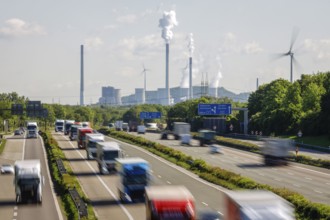 Many lorries driving on the A2 motorway, in the background the Uniper coal-fired power plant