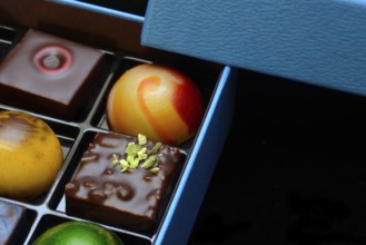 Chocolates in box, black background