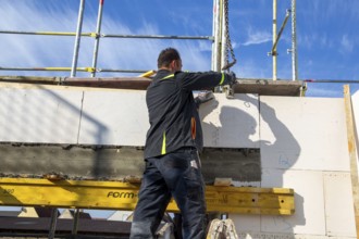 Bricklayer works on a new detached house