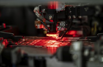 Robotic machine manufacturing semiconductor computer ship at a stall to show investors, during The