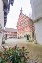 View of a red half-timbered house, town hall, through an alley with cobblestones, Großbottwar,